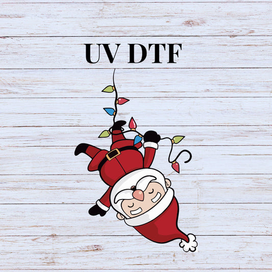 UV DTF Sticker print. Santa hanging from Christmas lights decal, tumbler decal. UV wrap for glass can tumbler.#7092